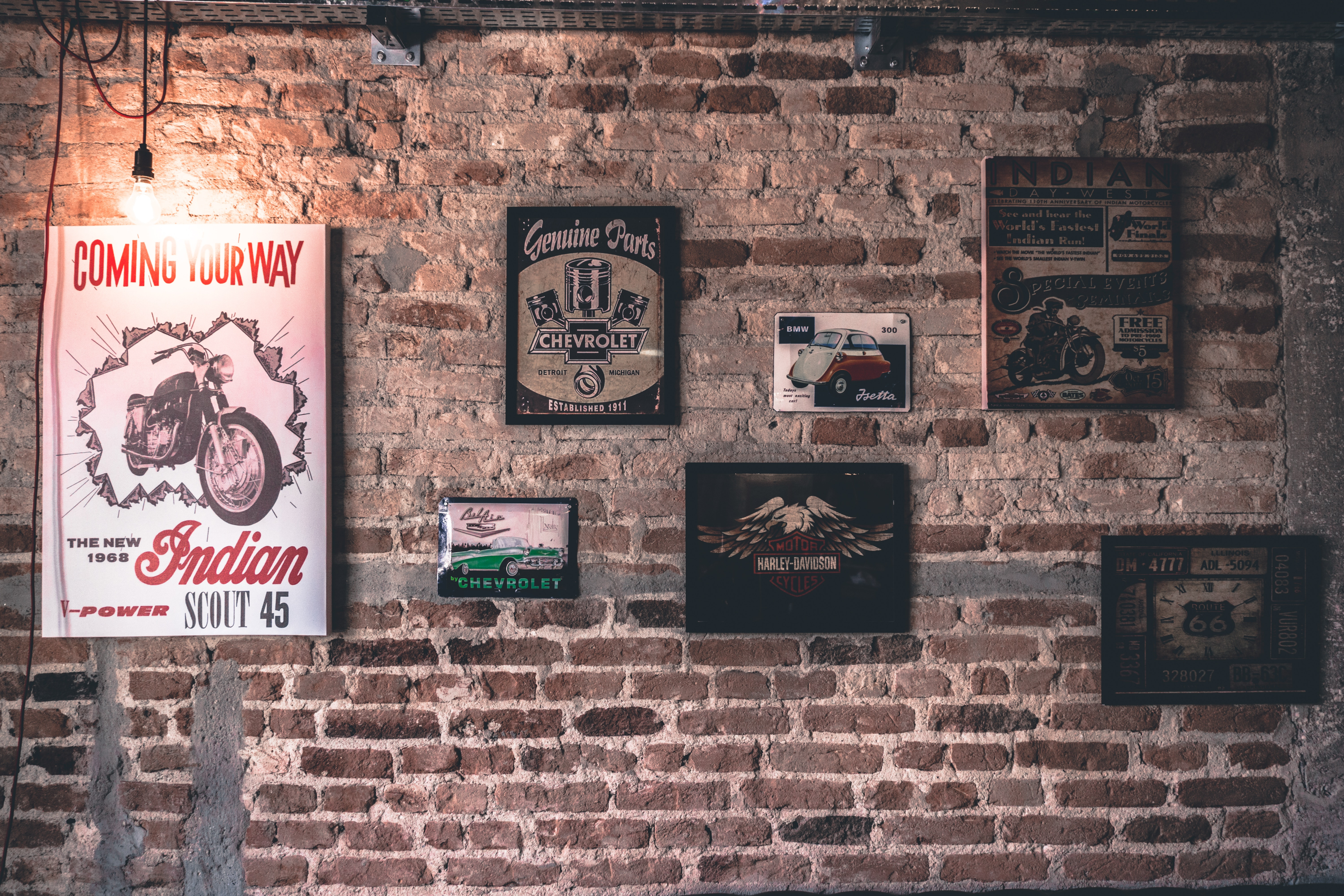 gallery of collectible posters on brick wall