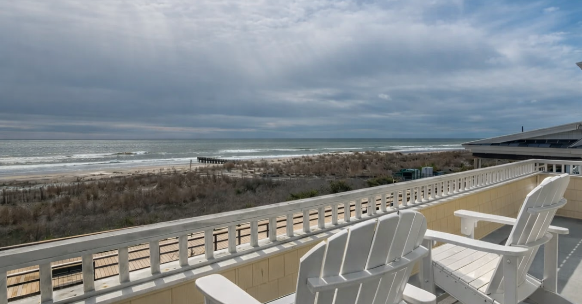 Oceanfront balcony view with Adirondack chairs overlooking the beach and waves at the Jersey Shore