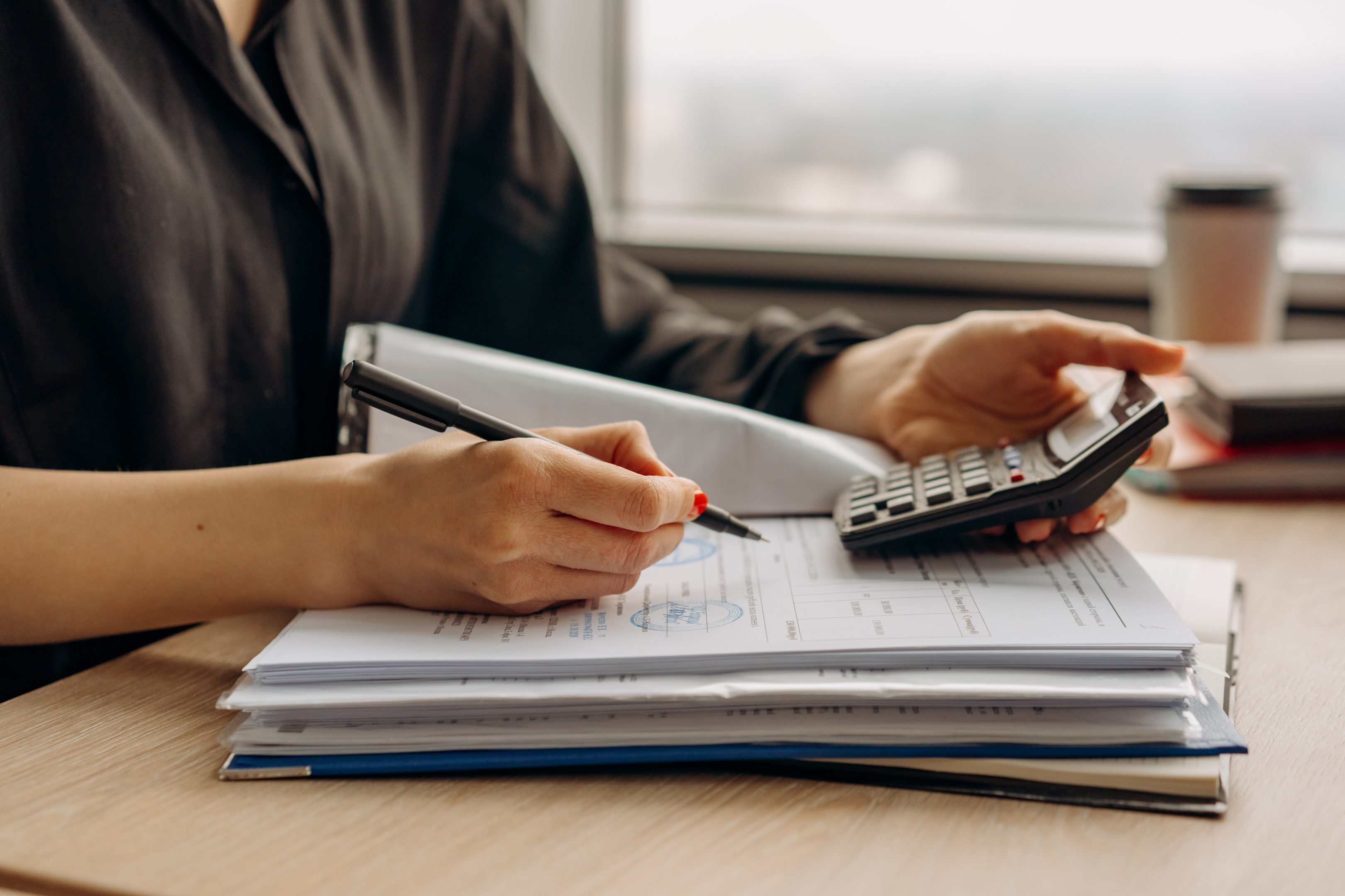 Person Keeping Track On The Tax Savings And Payroll Taxes To Save Money