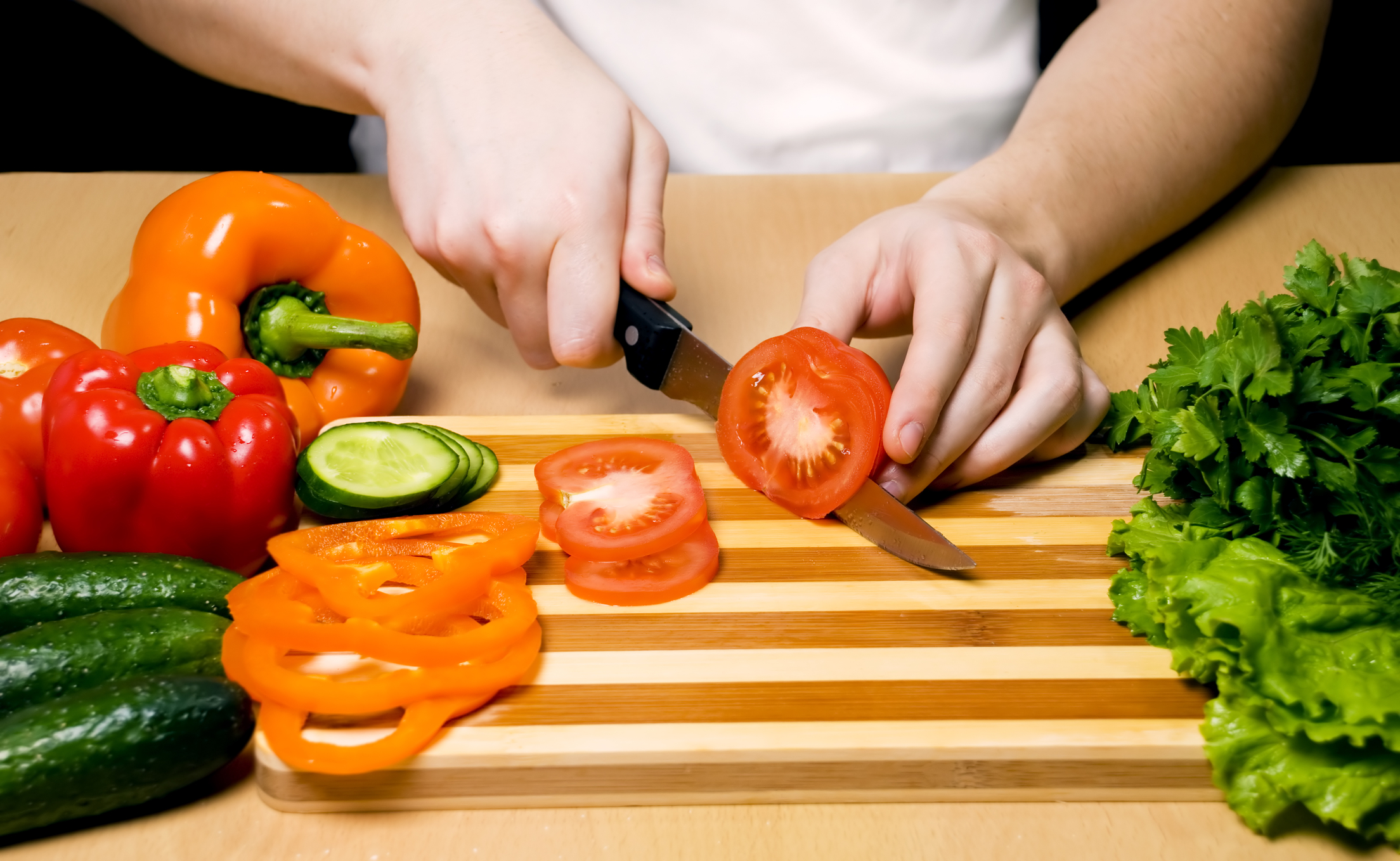 slicing tomato on a board