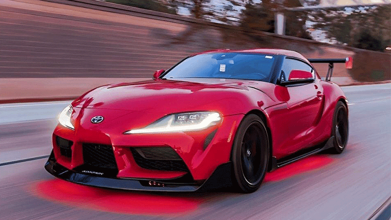 Red car with red underlight on the road