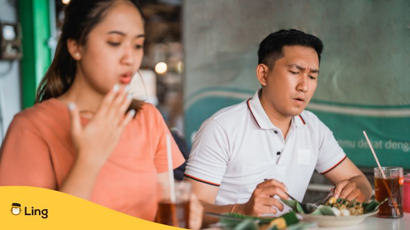 Man with spicy expression eating