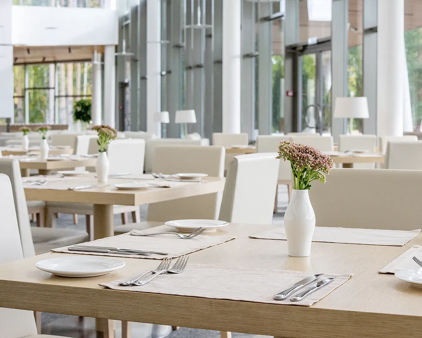 Elegant restaurant dining room with neatly set tables and modern interior