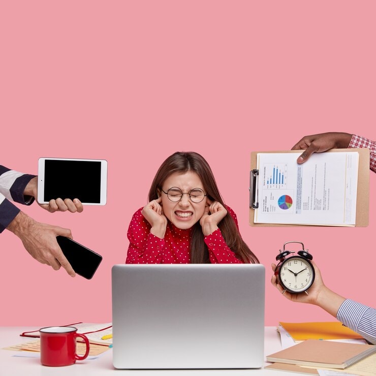 Stressed woman at a laptop covering her ears while surrounded by hands holding a phone, tablet, clipboard, and alarm clock — symbolizing digital distractions and multitasking overload.