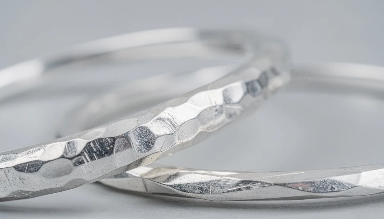 A detailed view of hammered silver bangles showcases their textured surfaces reflecting light, highlighting the elegance and craftsmanship of these solid silver bangles. This unique collection of silver bracelets and bangles offers a stylish statement piece perfect for any occasion.