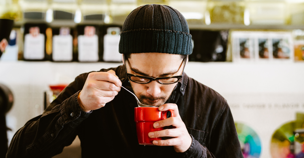 man tasting coffee
