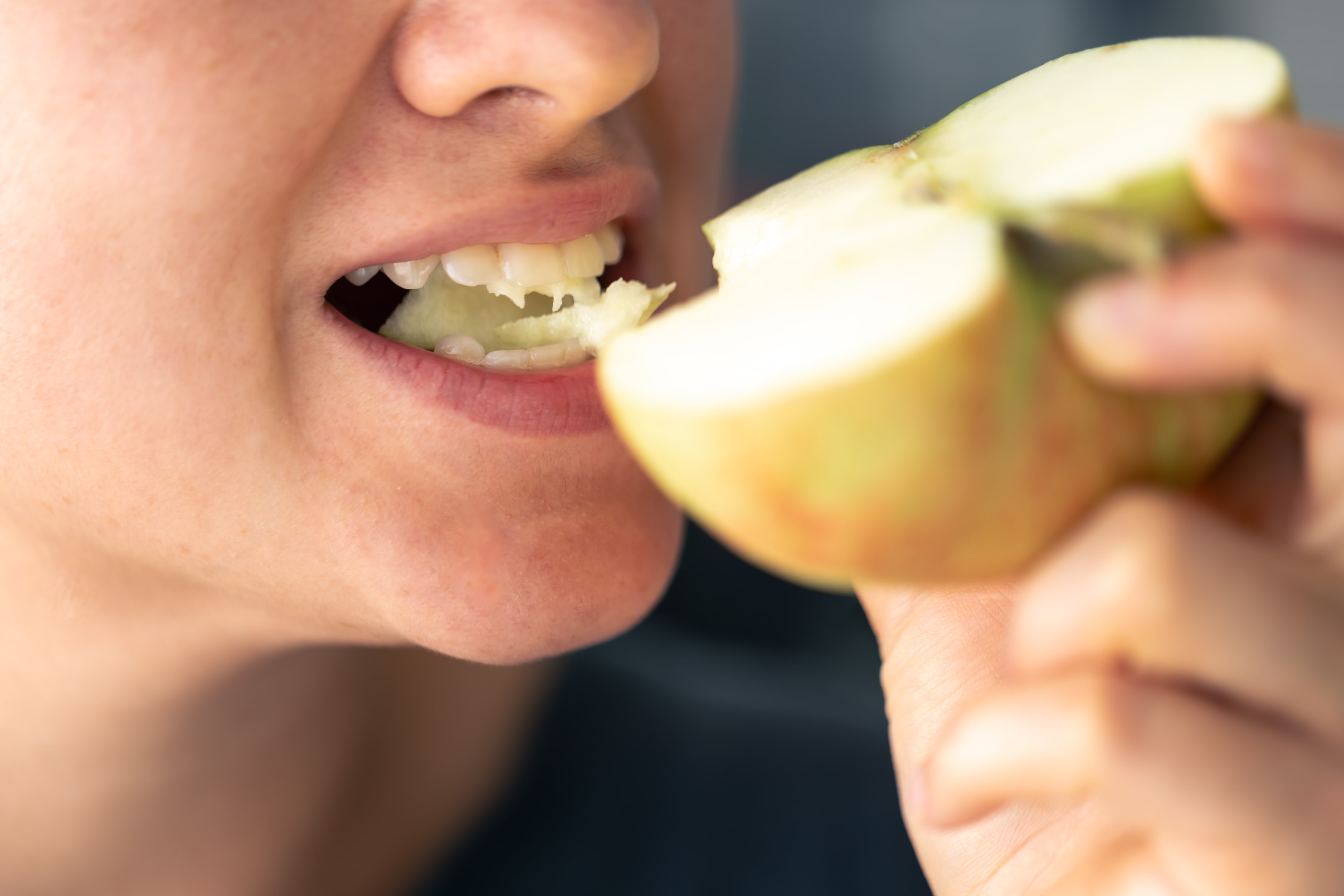 a woman eating an apple