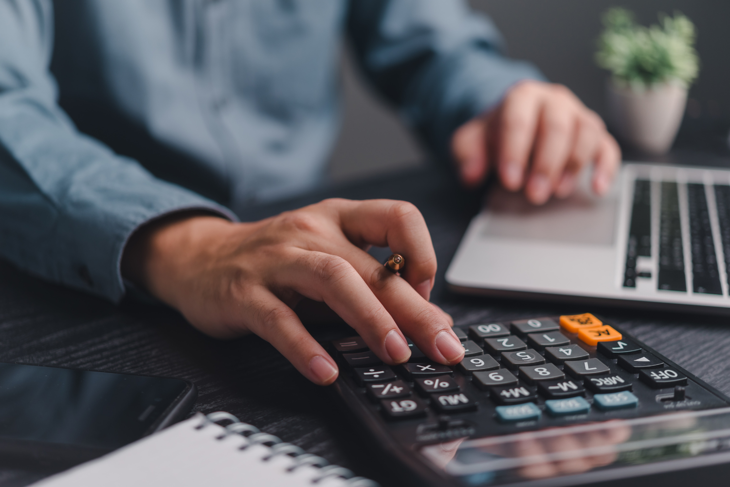 Business professional using a calculator.