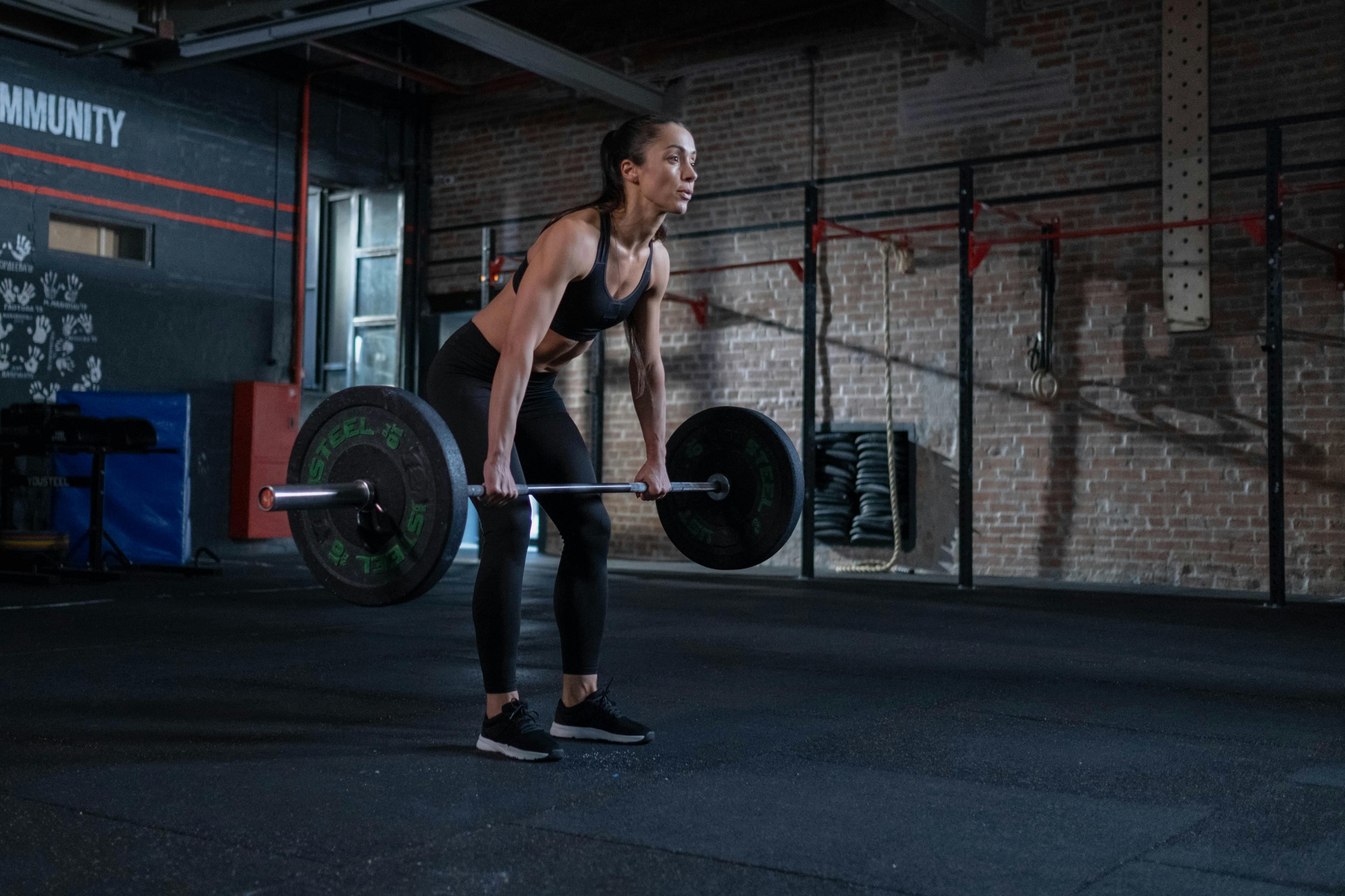 Photo by cottonbro studio: https://www.pexels.com/photo/woman-in-black-sportswear-lifting-a-barbell-7674497/