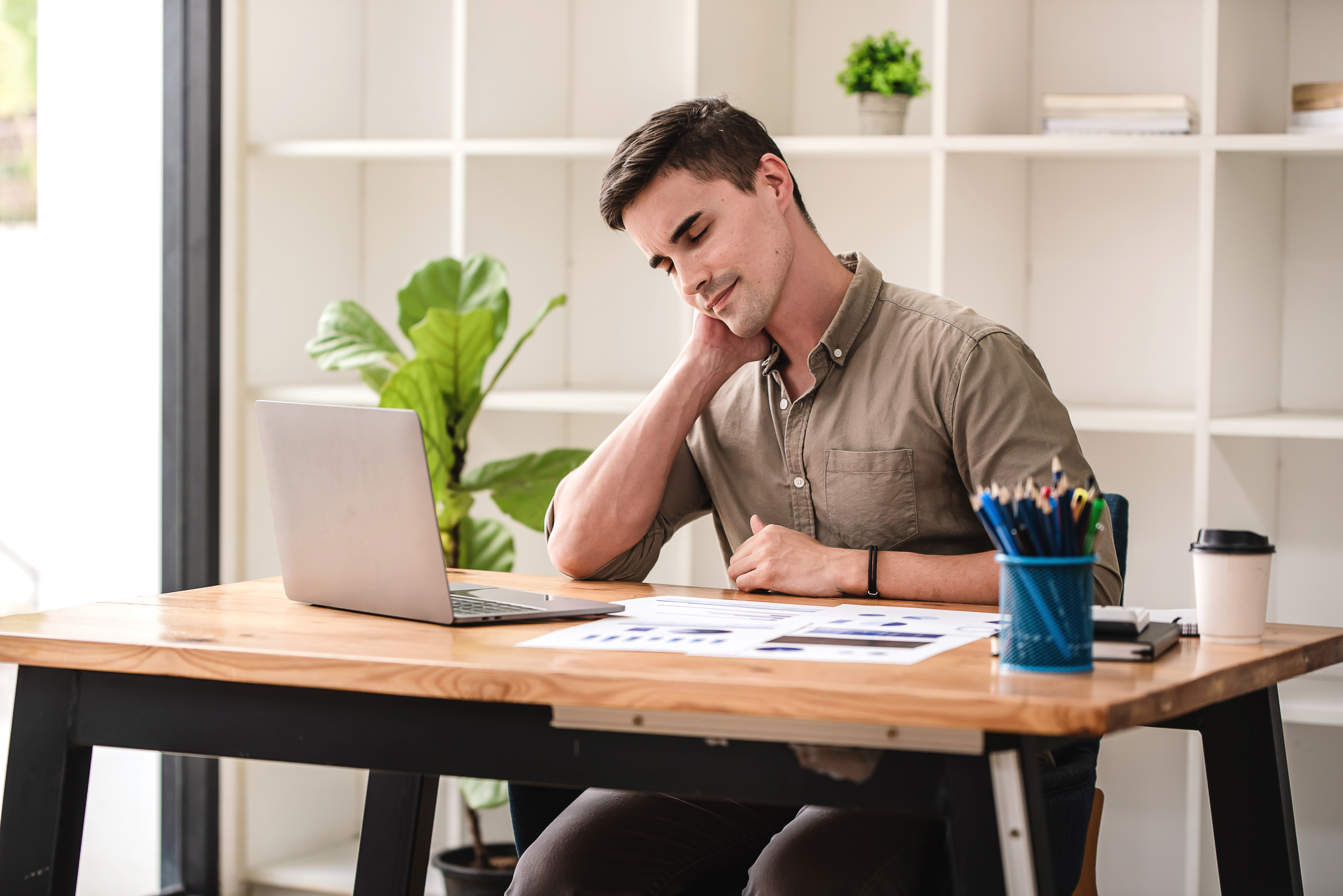 Young concord west staff memeber sitting at table with hunched posture.