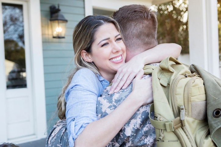 Young wife welcoming husband home from deployment. 