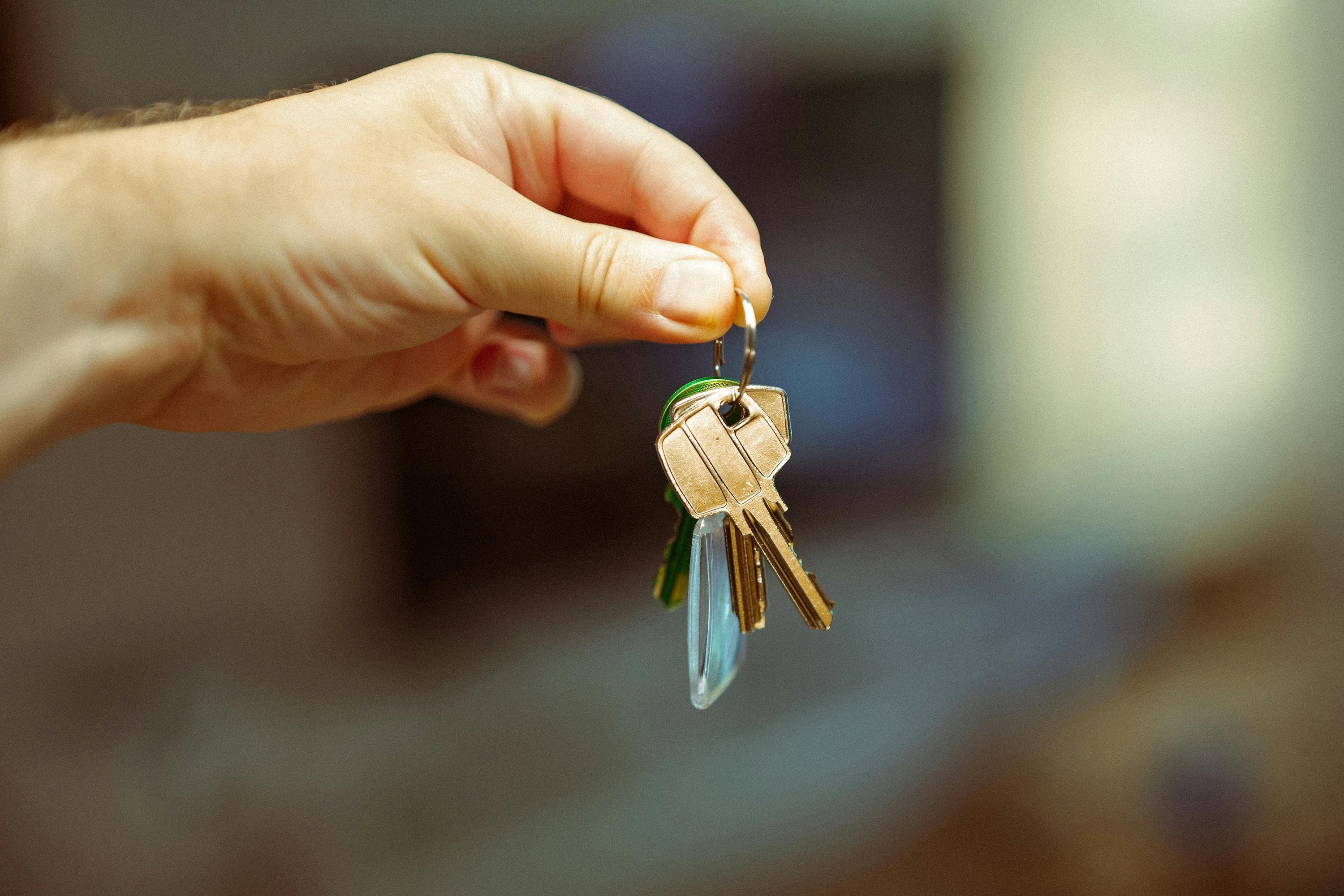 Investor holds keys to newly purchased rental property.