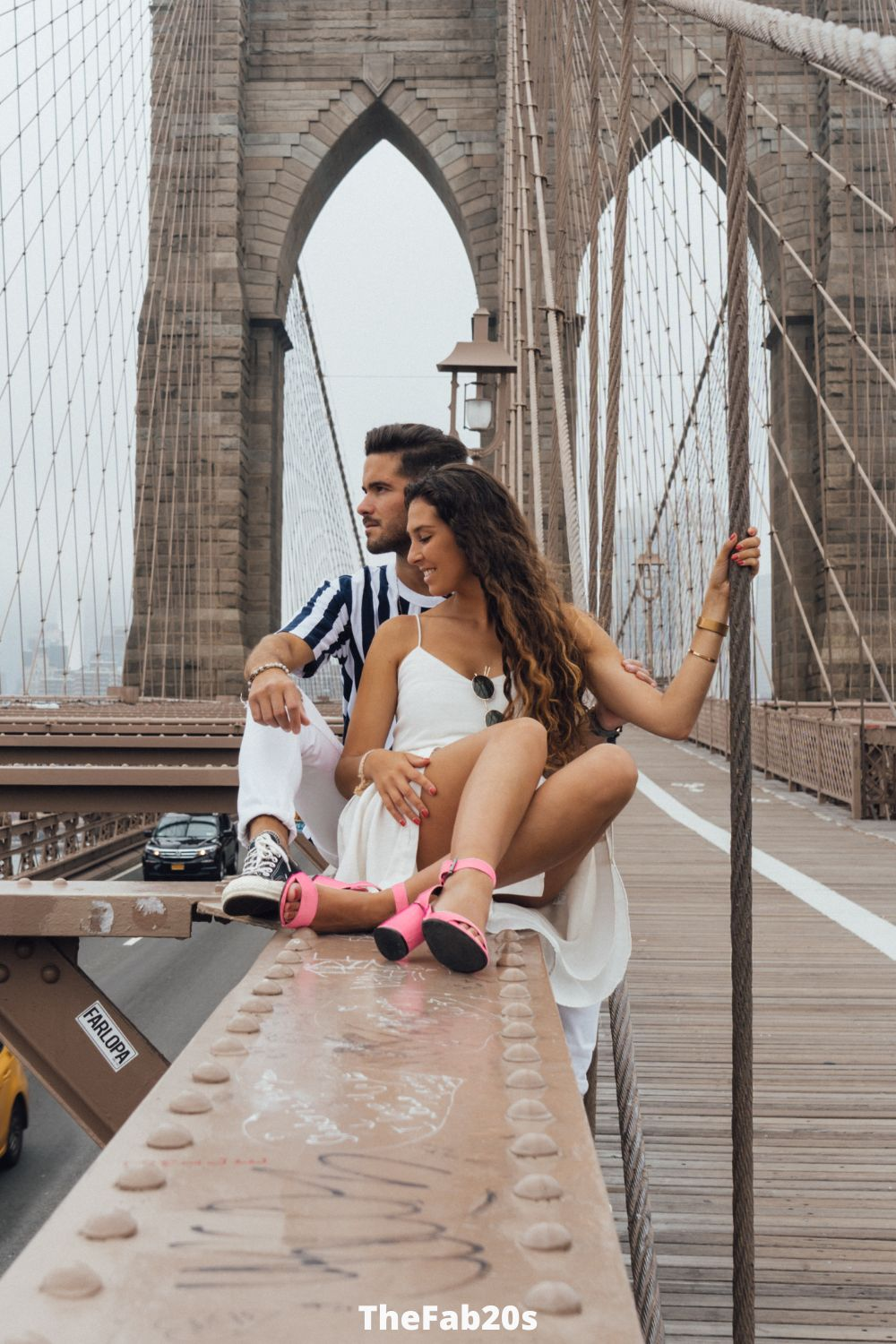Couple on a bridge looking down - Featured in Cancer and Sagittarius Article
