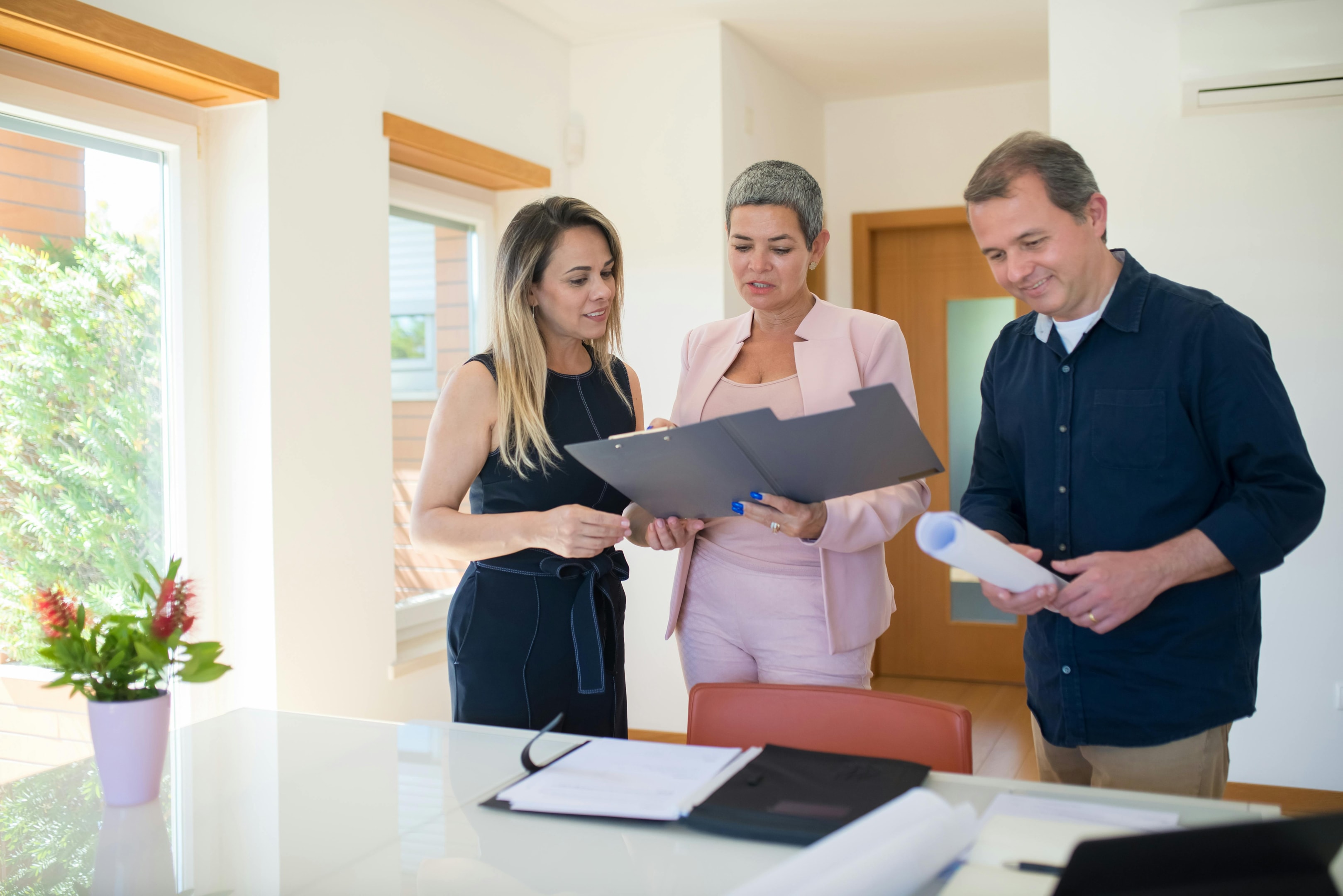 Motivated sellers review property information with real estate investor.