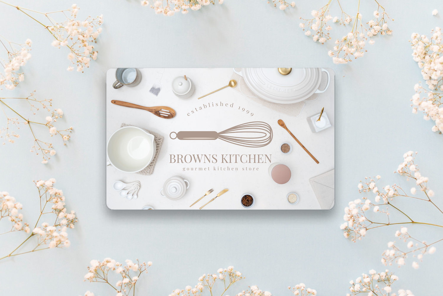 A Browns Kitchen Gift Card on a light blue background, surrounded by baby's breath flowers.