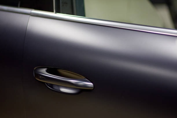 Close-up of a car with Paint Protection Film (PPF) applied, showcasing its clear and seamless finish for protecting the paint.