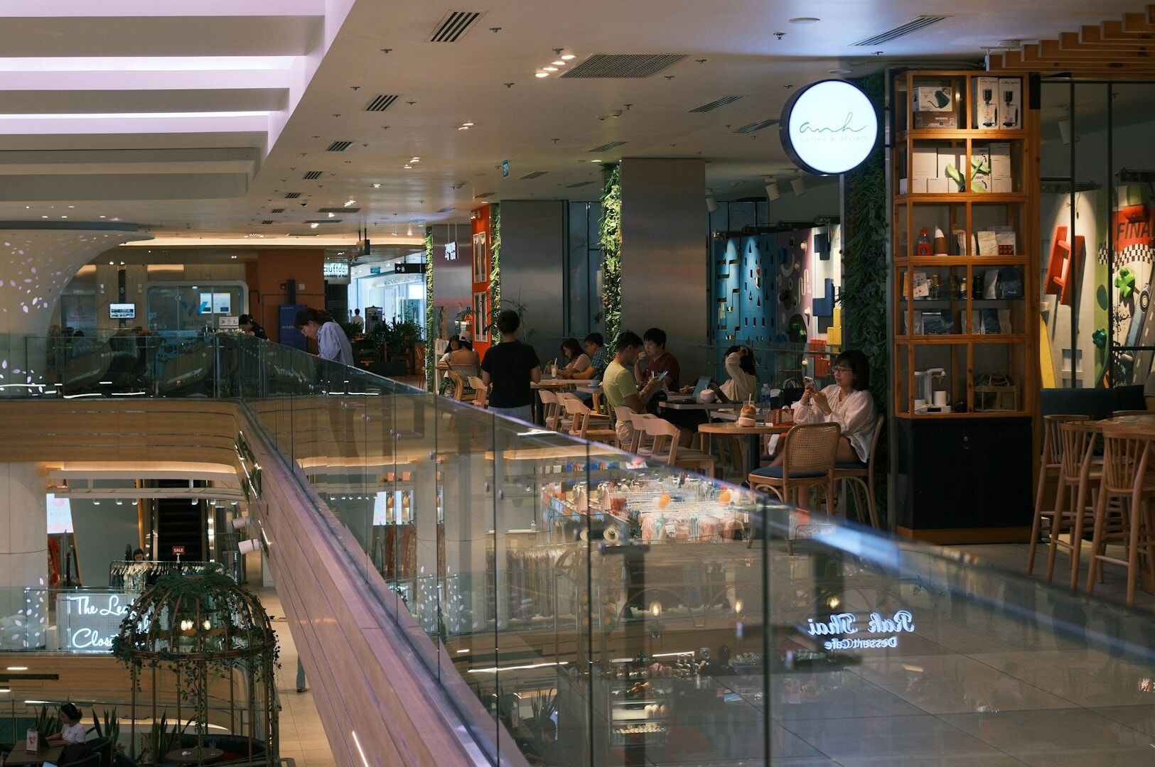 Sleek glass railing overlooking a lively hawker centre, showcasing the vibrant atmosphere of popular food courts.