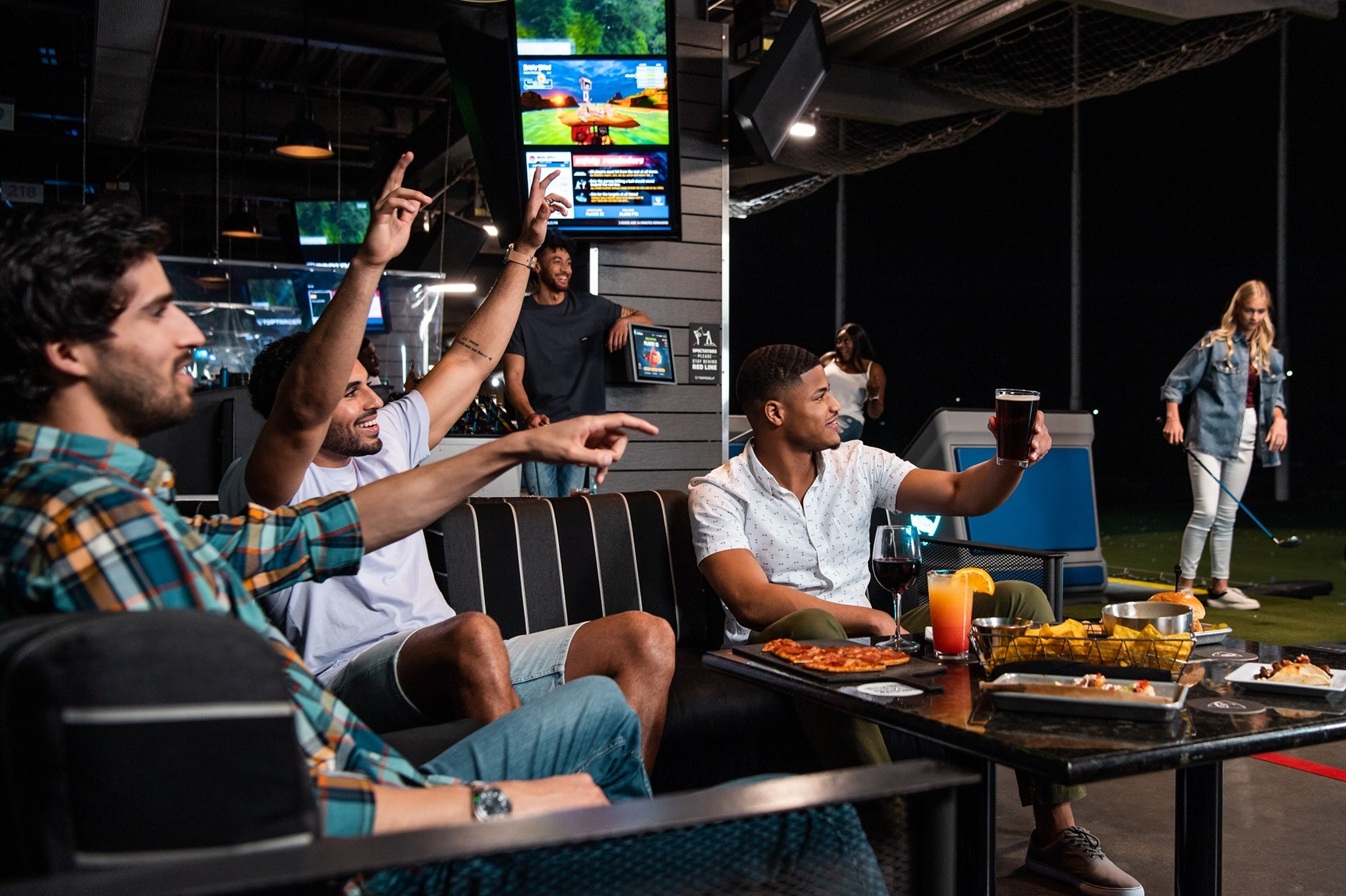 A corporate group playing games at Topgolf 