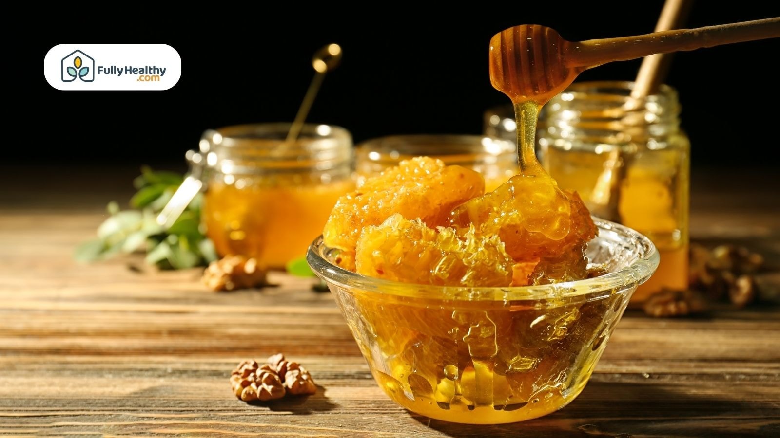 Fresh honeycomb with dripping honey in glass bowl