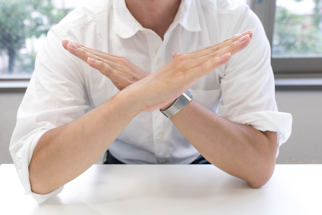 Business professional signaling to reject or walk away from a supplement vendor due to poor quality or safety risks