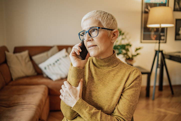 Short haired blonde woman on her cell phone. 