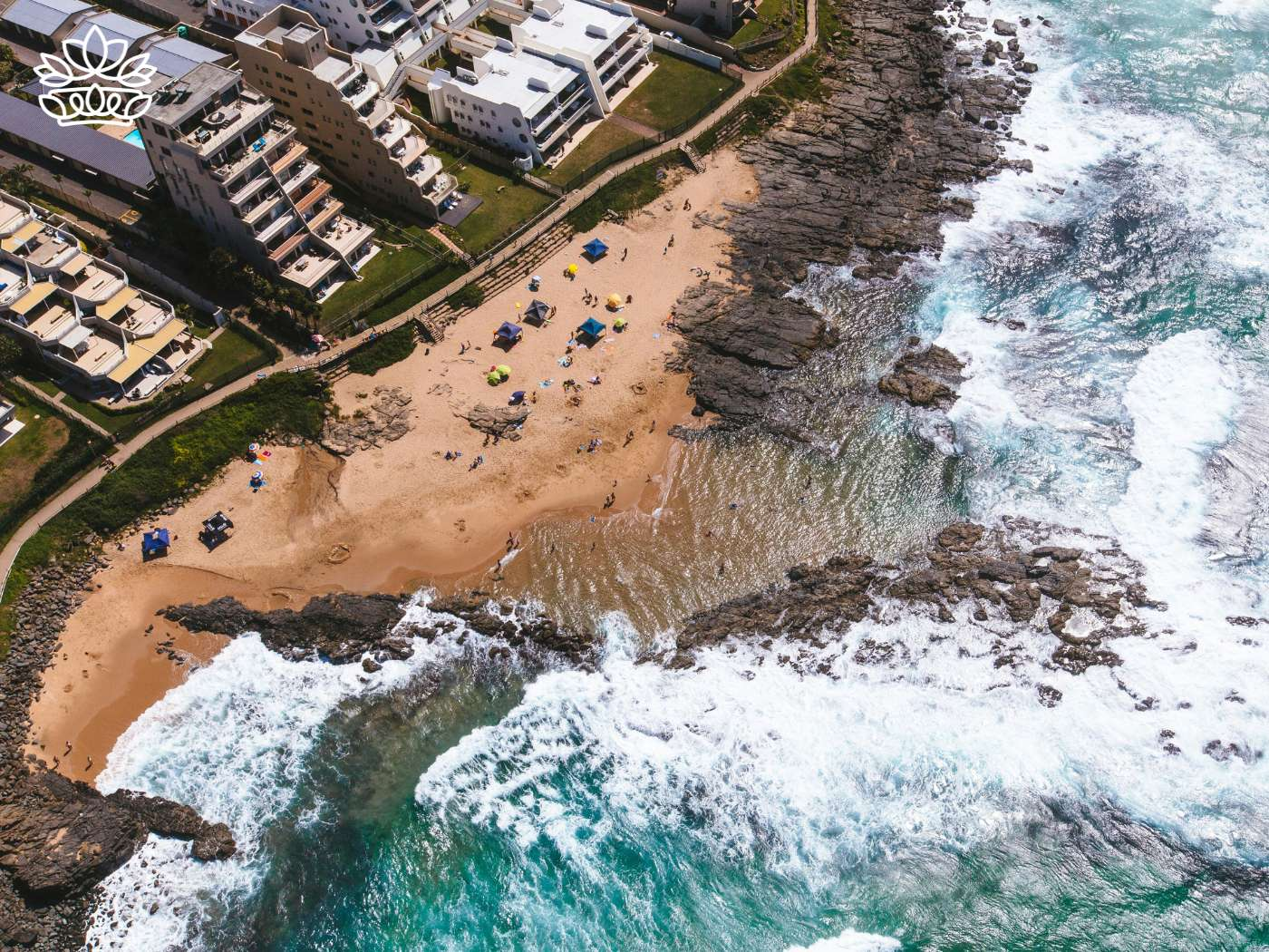 Aerial view of a bustling beach in Durban, showcasing the scenic coastline for the Durban Gift Box Delivery Collection, offering nationwide delivery and excellent service by Fabulous Flowers and Gifts.
