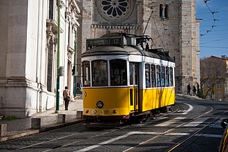 A photo of a crowded street in Lisbon, Portugal, showing why is Lisbon worth visiting