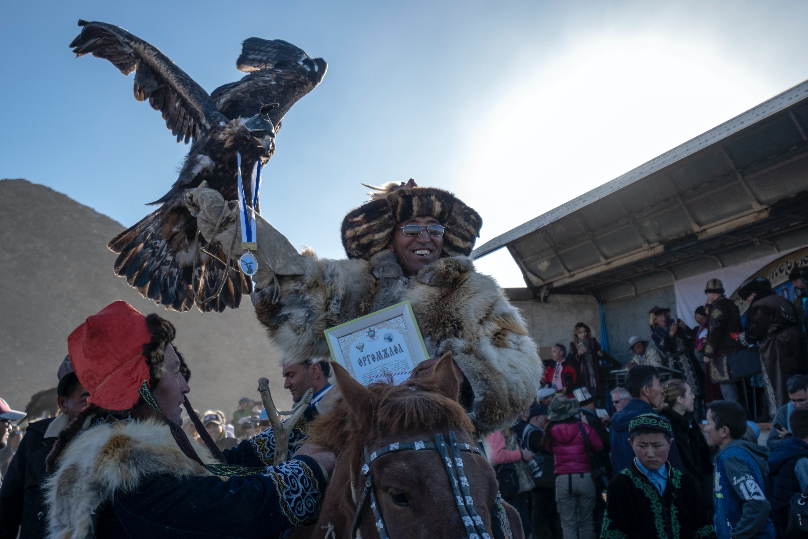 A group of eagle hunters in traditional dress at the Golden Eagle Festival in western Mongolia