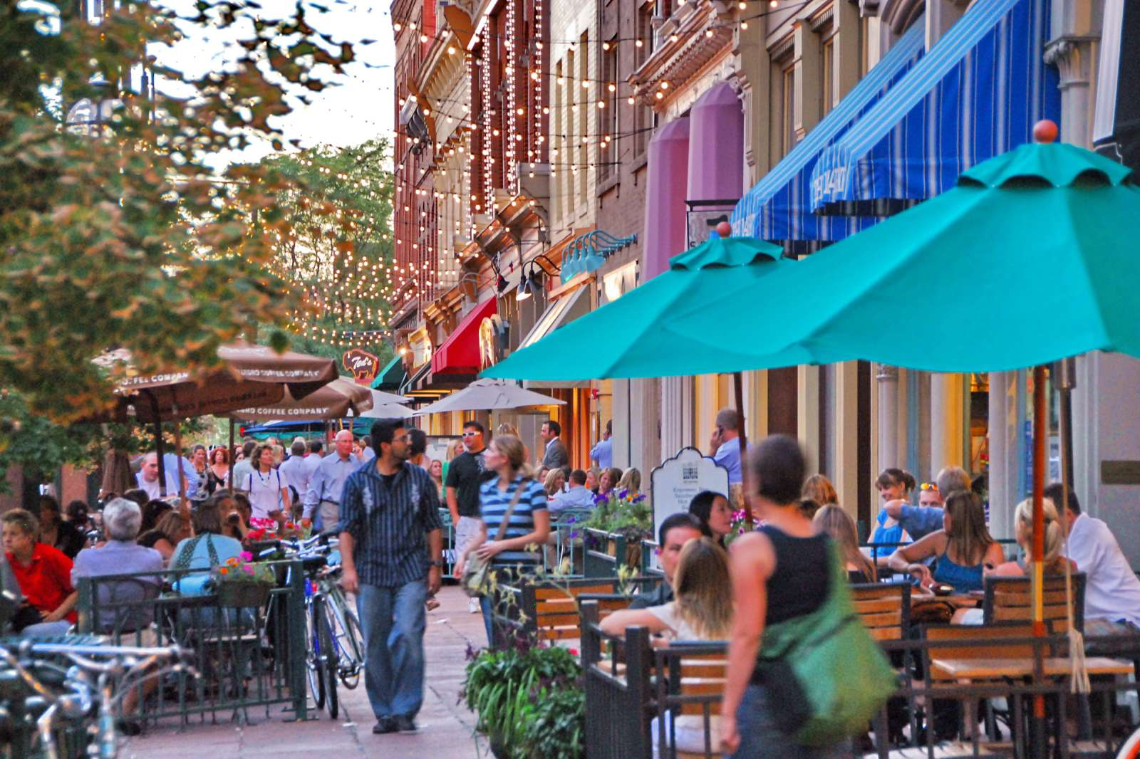 Revitalized public space in the heart of a historic district, where citizens enjoy enhanced street life and community events, showcasing the successful balance of historic preservation and modern construction, with features approved by national preservation programs and local historic designation guidelines.