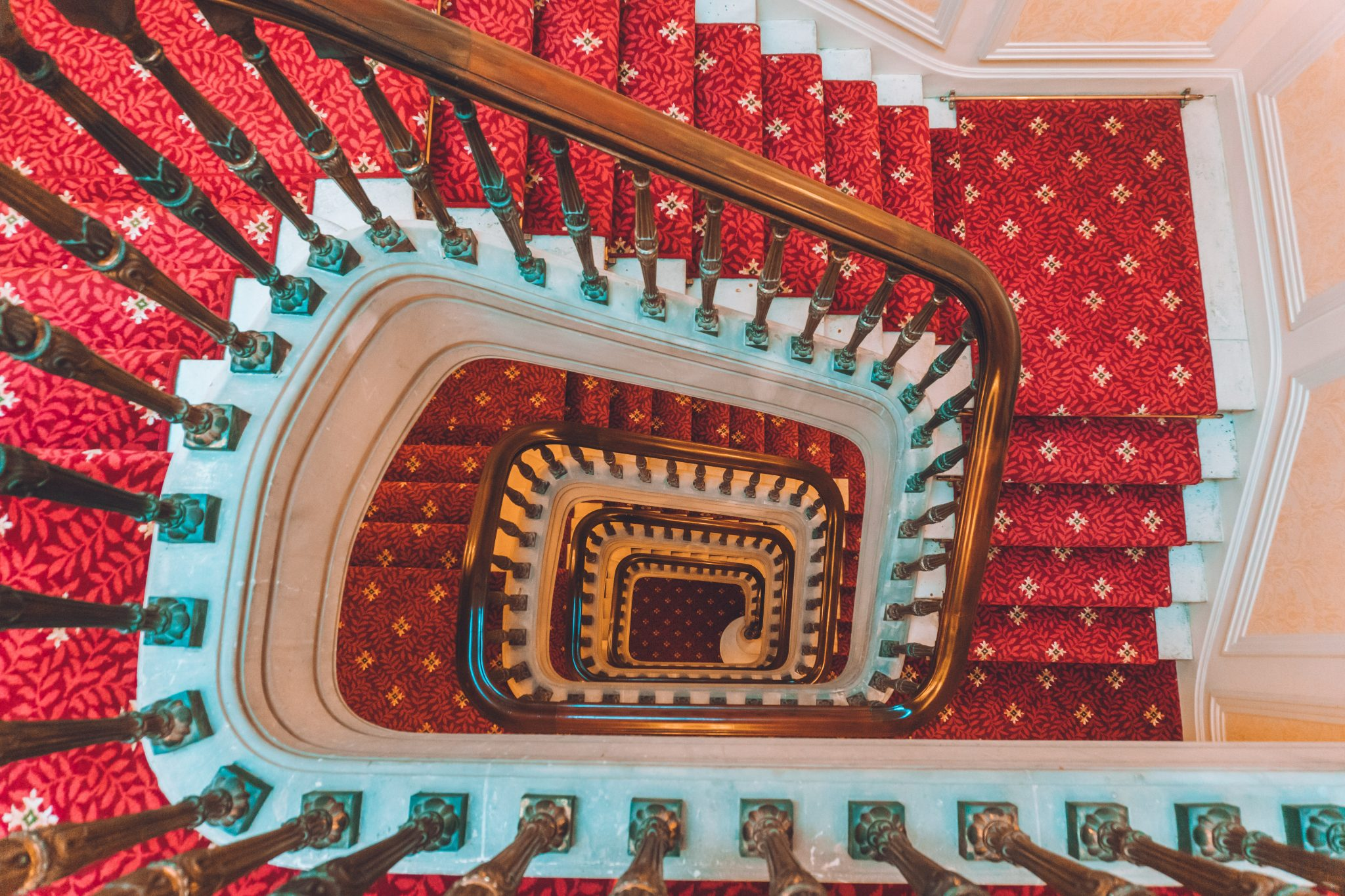 Architecture photo looking down a carpeted spiral staircase