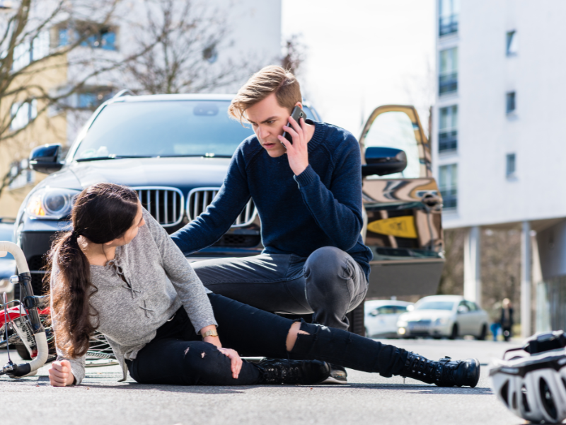 Image showing a person on the phone calling the police afte a hit and run.