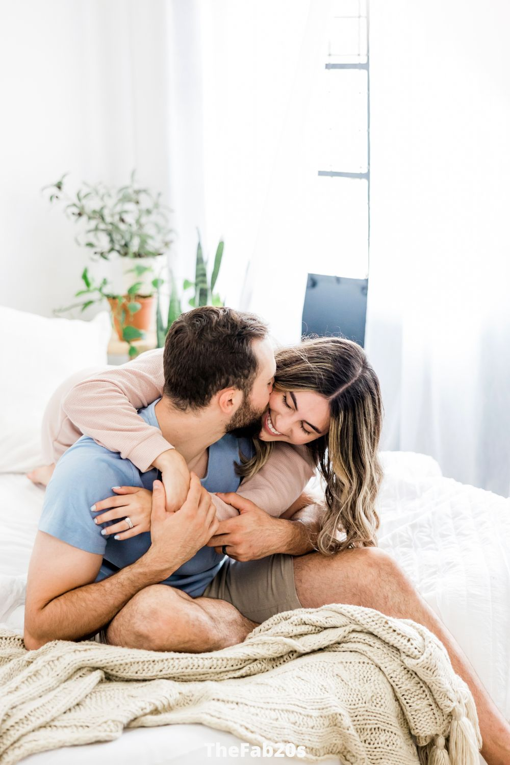 A loving couple embracing each other while lying in bed - Featured In Why Are Geminis Attracted To Scorpio