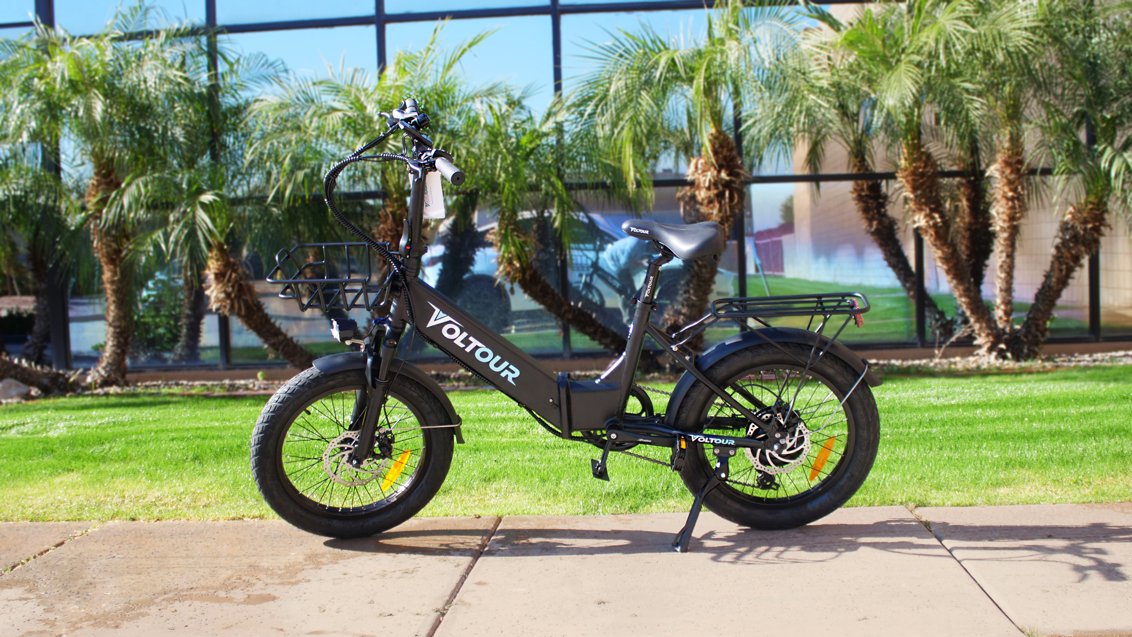 black foldable ebike in front of building