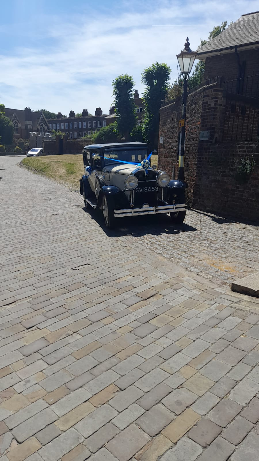 Vintage Buick parked on cobble streets of Rochester Castle 