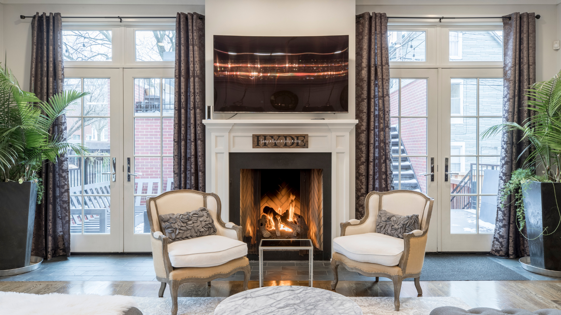 Large drawing room-style space - two French doors with long curtains on poles