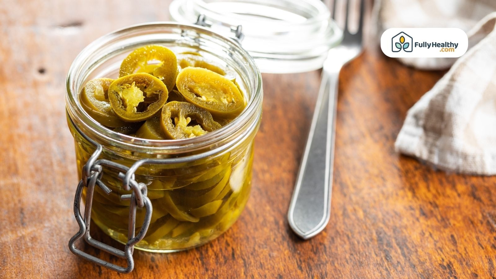 Glass jar filled with tangy pickled jalapeño slices