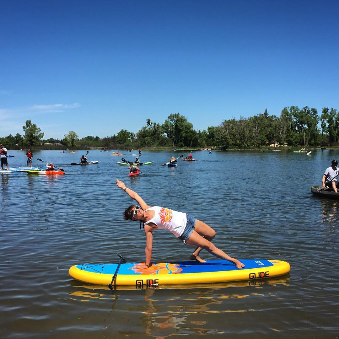 yoga on an inflatable paddle board