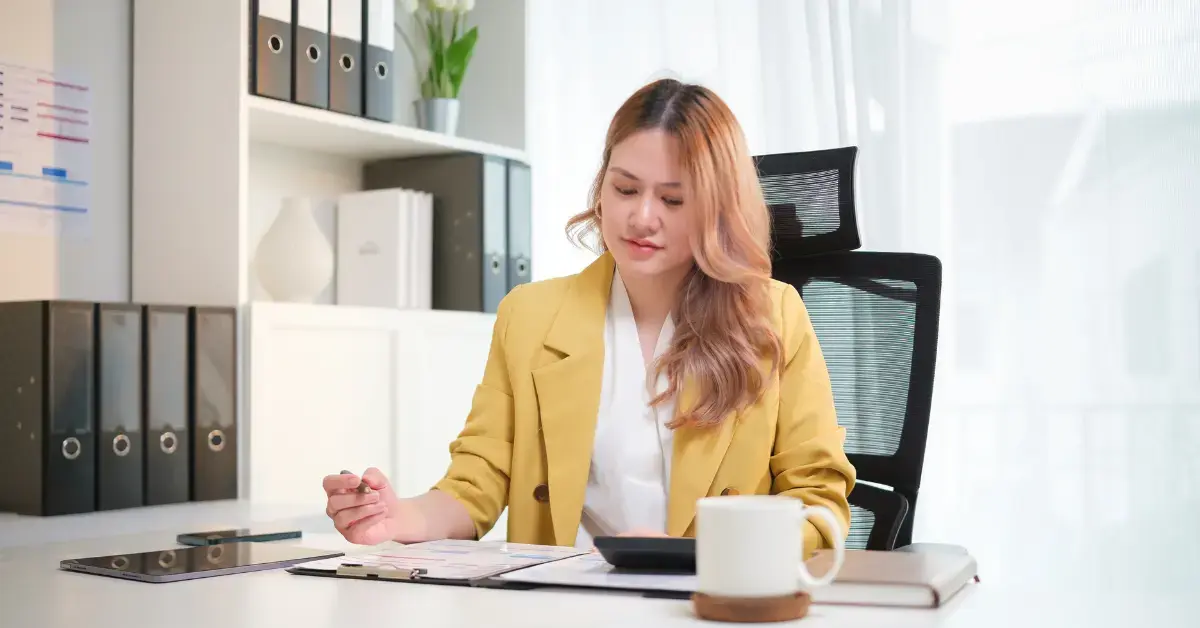 Woman reviewing IRS documents to understand what is a tax lien and how it can affect property.
