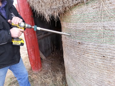 A hay probe being used to take core samples from a hay bale for forage analysis