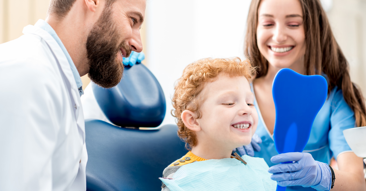 An image of a thriving dental practice with a happy child smiling into the mirror after a teeth cleaning.