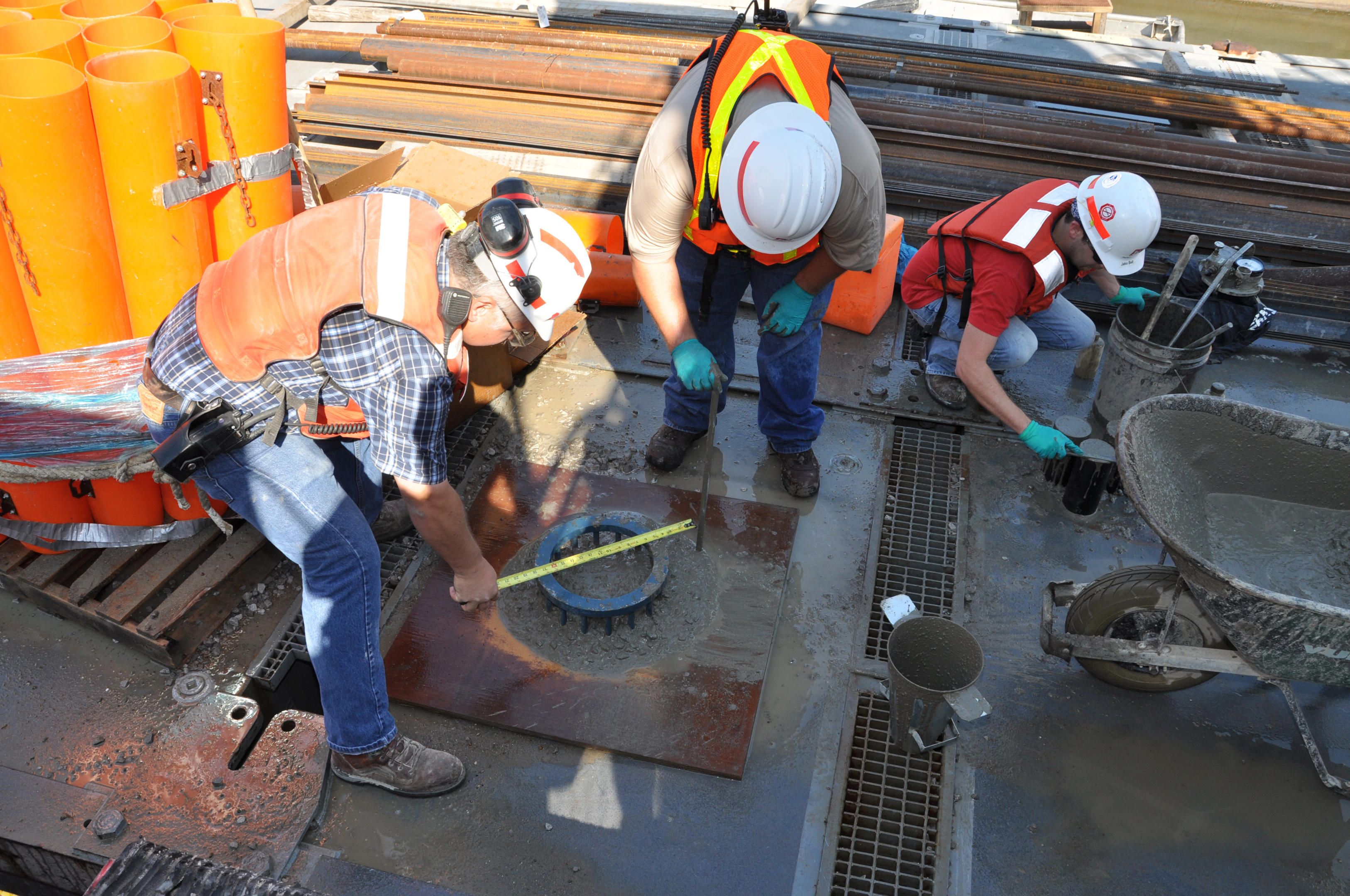 A picture of a construction site with workers testing self consolidating concrete