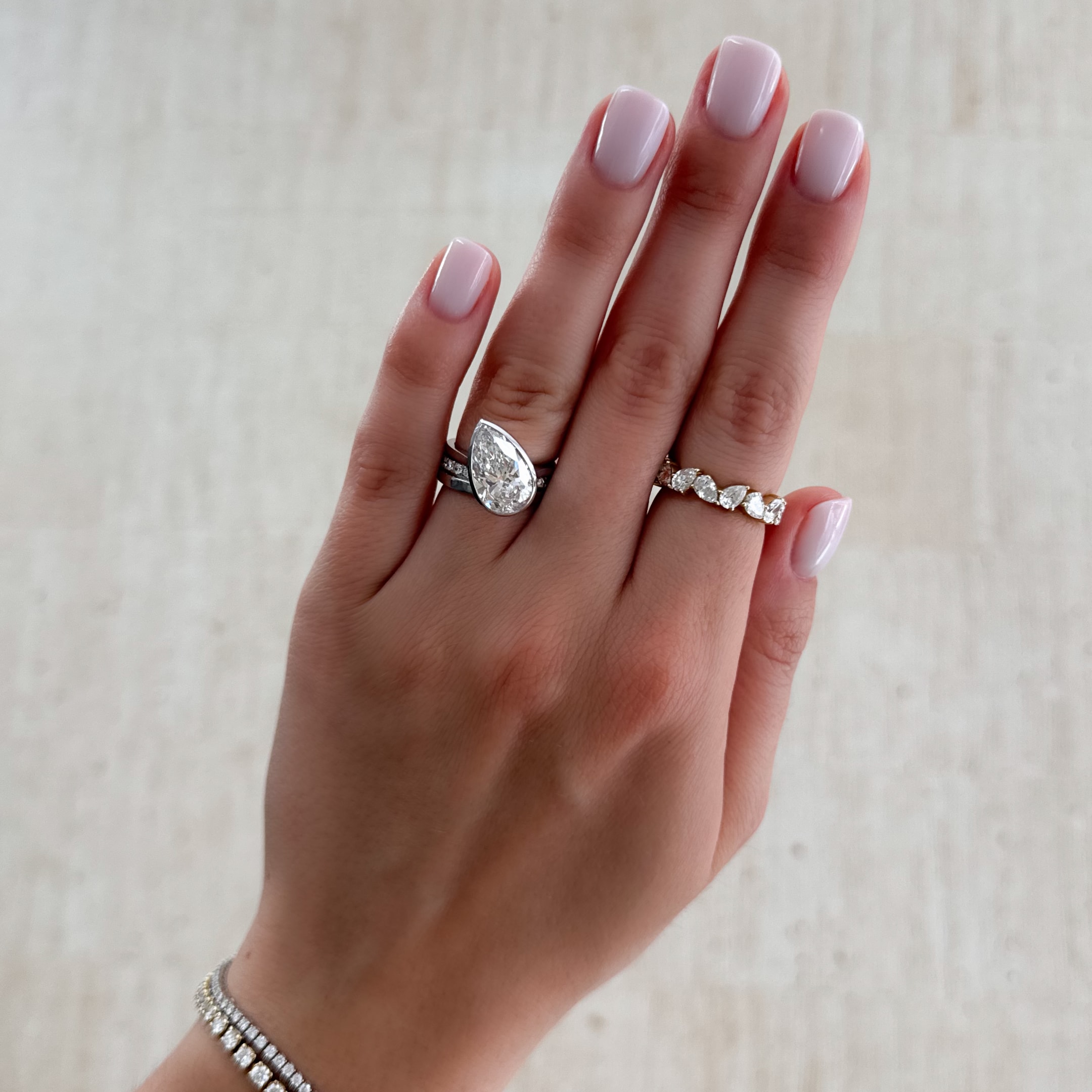 penumbra bezel set engagement ring wiht a tilted pear cut dimaond