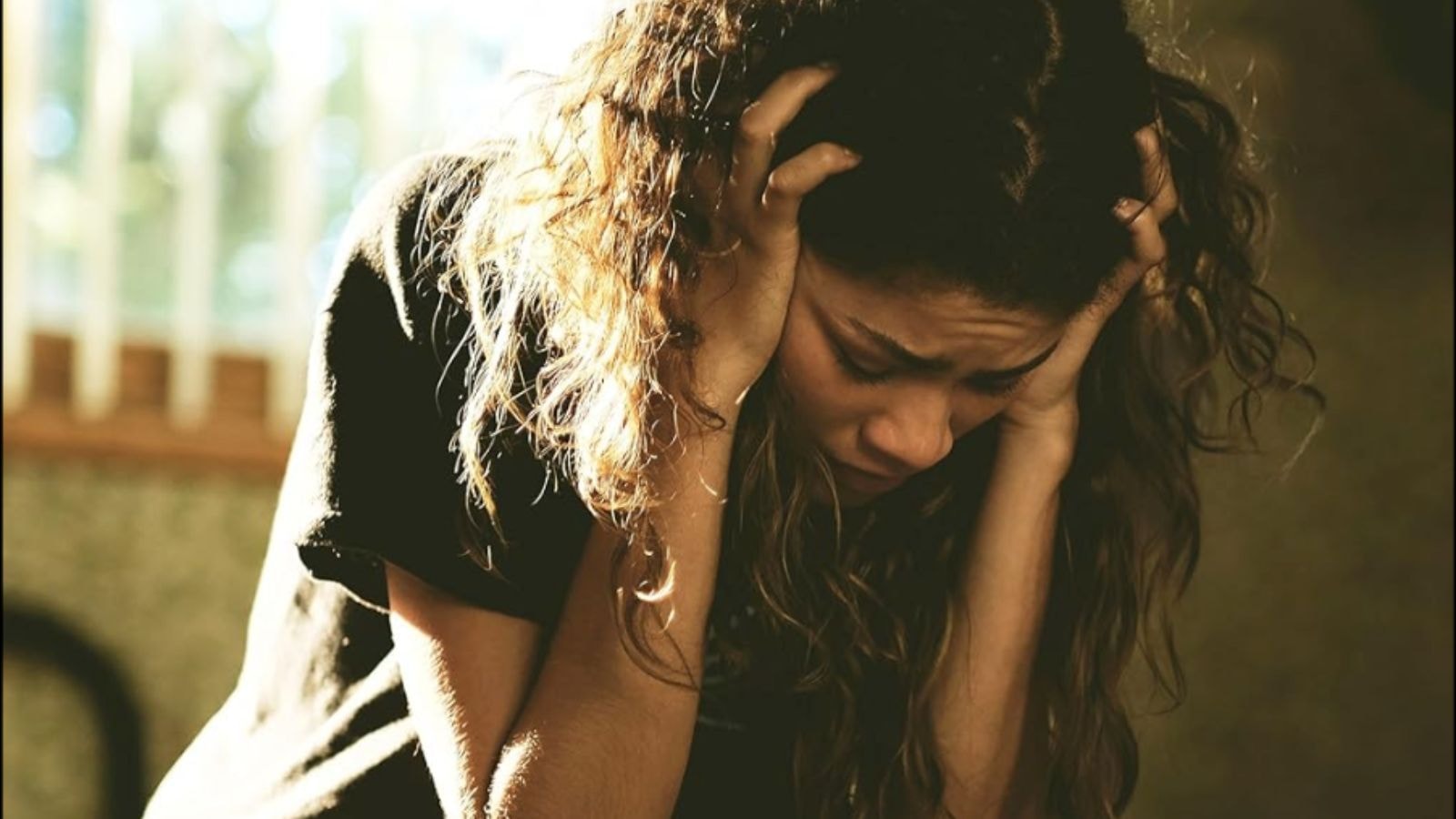 Euphoria still of Zendaya as Rue clutching her head in distress in Euphoria Season 2