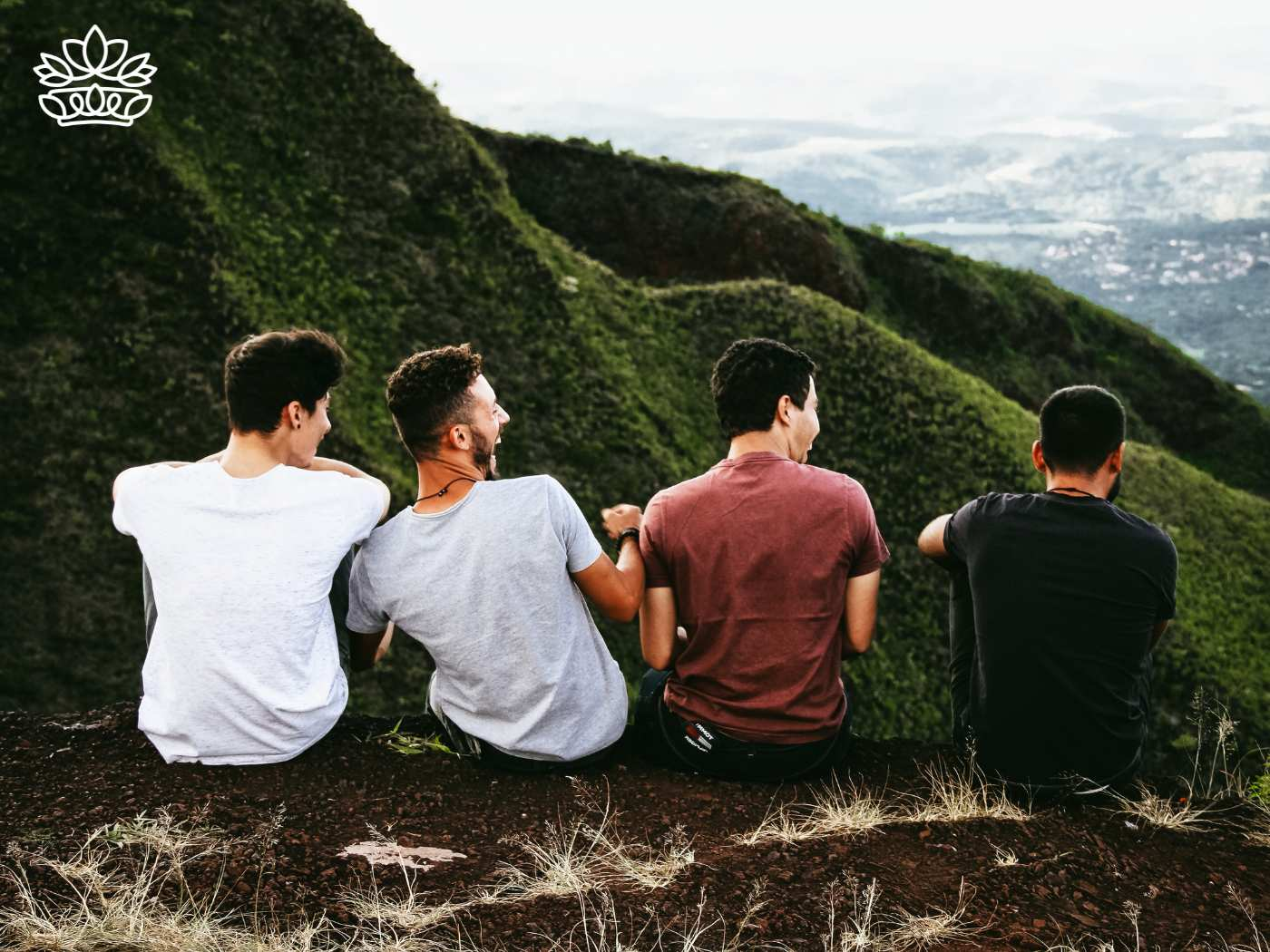 A group of four men sitting together on a hilltop, representing the Gift Boxes for Men Collection - Great items to add on a budget - Fabulous Flowers and Gifts