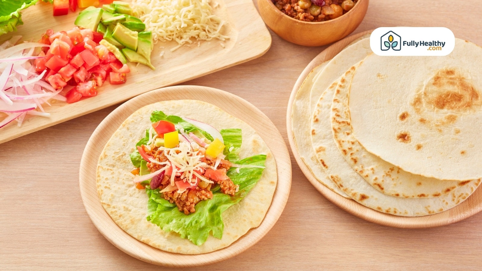 Tortilla filled with veggies, cheese, and seasoned meat ingredients.