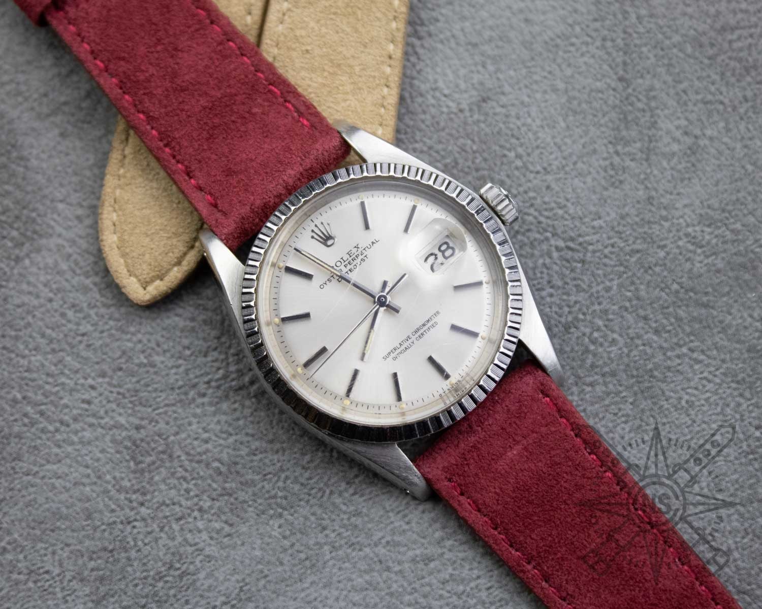 A stylish red suede watch strap displayed elegantly.