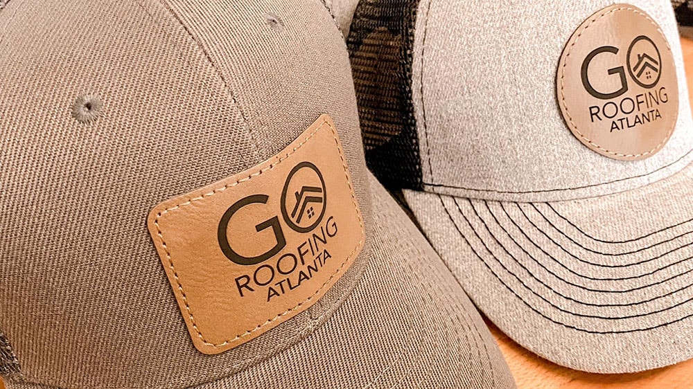 custom engraved leather patches on brown caps featuring a company logo
