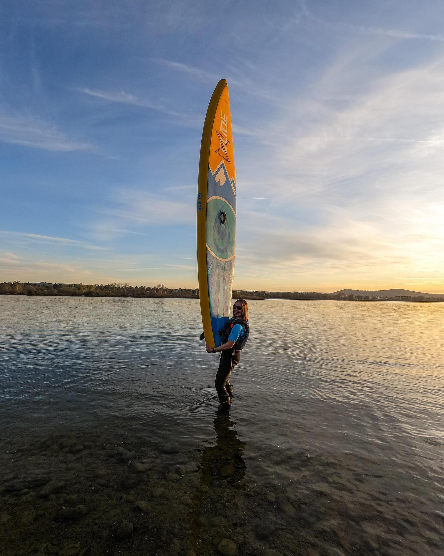 woman holding a touring paddle board