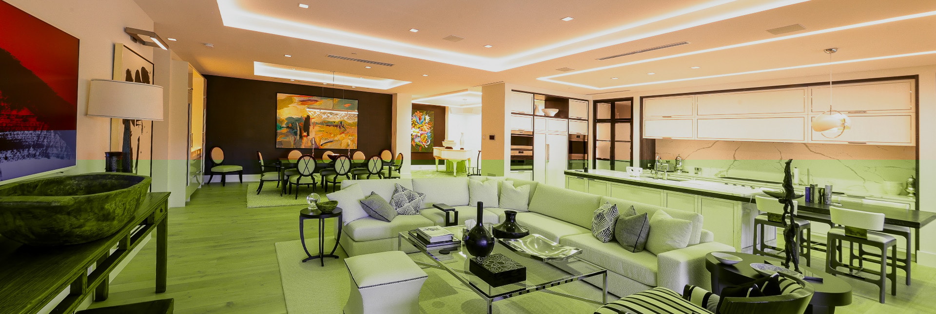 The image depicts a cozy home theater room featuring ambient recessed lighting dimmed low along the ceiling, creating a perfect ambiance for movie nights. The warm dim light output enhances the space, while the comfortable furniture invites relaxation in this residential entertainment area.