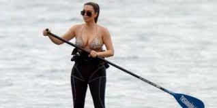 celebrity on a paddle board